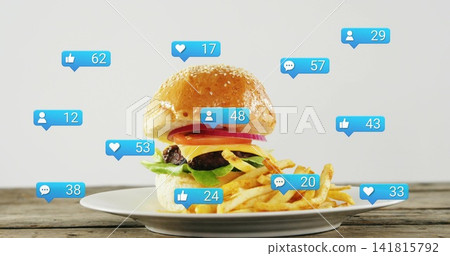 Featuring sesame bun burger and fries on white plate sitting on wood tabletop, with blue bubbles Featuring sesame bun burger and fries on white plate sitting on wood tabletop, with blue bubbles 141815792