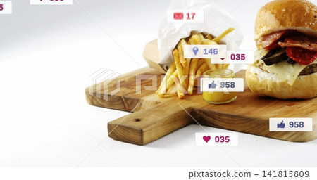 Showing sesame burger, paper fries on wooden board with handle in studio, sauce jar, social icons 141815809