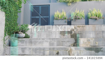 Showing concrete steps leading up to modern facade at entrance, with planter boxes, louvered vent Showing concrete steps leading up to modern facade at entrance, with planter boxes, louvered vent 141815894