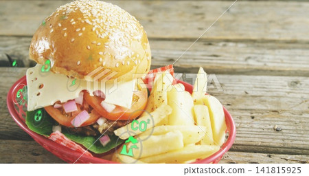 Showing sesame-bun burger with Swiss cheese, peppered fries in red-basket on table, CO2 overlay Showing sesame-bun burger with Swiss cheese, peppered fries in red-basket on table, CO2 overlay 141815925