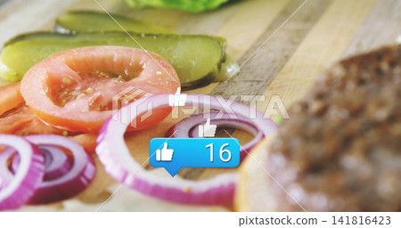 Featuring red onion rings sitting on wood board with tomato, pickle, burger bun, blue like icon Featuring red onion rings sitting on wood board with tomato, pickle, burger bun, blue like icon 141816423