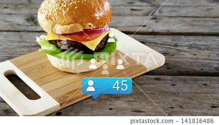Showing sesame-bun burger patty-cheese on rustic wood board showing white icons blue 45, copy space Showing sesame-bun burger patty-cheese on rustic wood board showing white icons blue 45, copy space 141816486