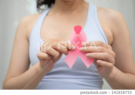 Breast cancer, pink ribbon at Asian senior lady for supporting awareness, symbol of World Breast Cancer Day. Breast cancer, pink ribbon at Asian senior lady for supporting awareness, symbol of World Breast Cancer Day. 141816733