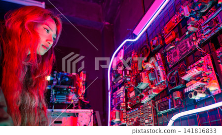 Asian woman wearing a black jacket hacking programming system check hacking hardware circuit in dark office, Cyber security agency developing, Computer electronics Asian woman wearing a black jacket hacking programming system check hacking hardware circuit in dark office, Cyber security agency developing, Computer electronics 141816833