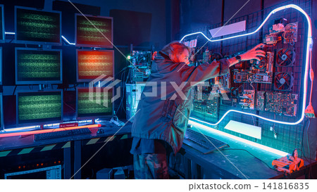 Asian woman wearing a black jacket hacking programming system check hacking hardware circuit in dark office, Cyber security agency developing, Computer electronics Asian woman wearing a black jacket hacking programming system check hacking hardware circuit in dark office, Cyber security agency developing, Computer electronics 141816835