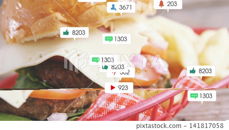Showing cheeseburger with sesame bun and melted white cheese in red basket, fries and notifications Showing cheeseburger with sesame bun and melted white cheese in red basket, fries and notifications 141817058