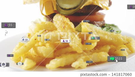 Showing seasoned crinkle-cut fries sitting on white plate, with burger, social icons and cursor Showing seasoned crinkle-cut fries sitting on white plate, with burger, social icons and cursor 141817060