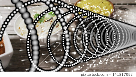 Displaying dotted spiral overlay on wood plank tabletop, highlighting round white rice bowl, sauces Displaying dotted spiral overlay on wood plank tabletop, highlighting round white rice bowl, sauces 141817092
