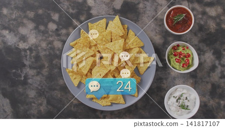 Displaying gray plate piling chips on dark tabletop, with three white bowls and blue 24 badge Displaying gray plate piling chips on dark tabletop, with three white bowls and blue 24 badge 141817107