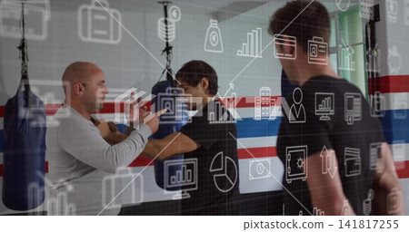 Three men training around hanging heavy bags in gym, gray-top coach guiding hands with data overlay Three men training around hanging heavy bags in gym, gray-top coach guiding hands with data overlay 141817255