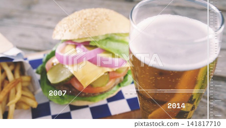 Featuring sesame-seed burger sitting on weathered wooden table at patio, with fries, pint, timeline Featuring sesame-seed burger sitting on weathered wooden table at patio, with fries, pint, timeline 141817710
