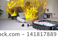Sitting male typing on laptop on floor in bedroom, yellow particles rising, open suitcase 141817889
