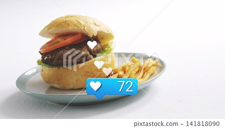 Displaying hamburger and fries on pale blue-gray plate in studio, hearts and 72 badge, copy space Displaying hamburger and fries on pale blue-gray plate in studio, hearts and 72 badge, copy space 141818090