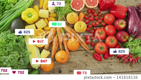Displaying produce spread on wooden table, with carrots, oranges, avocado, social-media icons Displaying produce spread on wooden table, with carrots, oranges, avocado, social-media icons 141818116