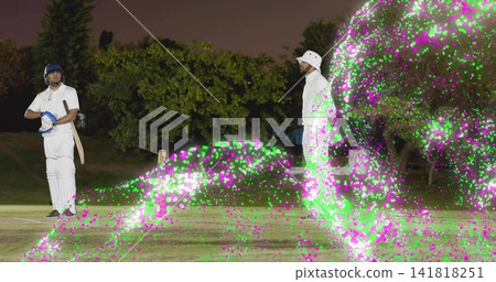 Standing batter in white kit holding bat at crease on floodlit pitch, magenta lights, copy space Standing batter in white kit holding bat at crease on floodlit pitch, magenta lights, copy space 141818251