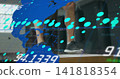 Standing man's legs wearing dark shorts, white socks, dark sneakers on stage with cyan overlays 141818354