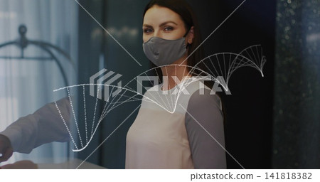 Standing masked woman in pink top facing camera at reception, showing DNA helix on glass partition Standing masked woman in pink top facing camera at reception, showing DNA helix on glass partition 141818382