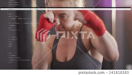 Throwing punches woman in gray athletic tank top training at gym, red hand wraps, code overlay Throwing punches woman in gray athletic tank top training at gym, red hand wraps, code overlay 141818383