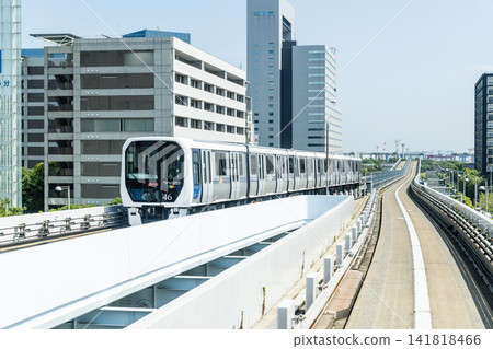 View of a New Transit Yurikamome line train running on the elevated track in Koto, Tokyo, Japan. It's an automated guideway transit service in Tokyo. View of a New Transit Yurikamome line train running on the elevated track in Koto, Tokyo, Japan. It's an automated guideway transit service in Tokyo. 141818466