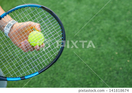 Holding tennis ball on racket before serve Holding tennis ball on racket before serve 141818674