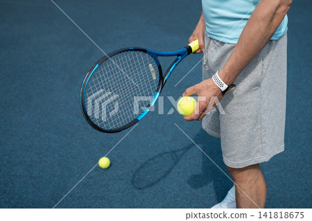 Holding tennis racket and ball before practice Holding tennis racket and ball before practice 141818675