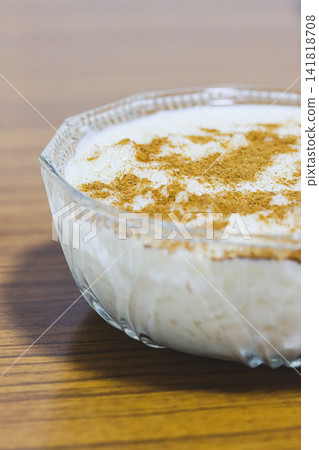 Homemade Spanish Rice Pudding with Cinnamon on Wooden Table Homemade Spanish Rice Pudding with Cinnamon on Wooden Table 141818708