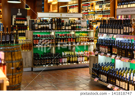 A well-lit duty-free shop with an extensive wine display within the Departures terminal of Tbilisi International Airport A well-lit duty-free shop with an extensive wine display within the Departures terminal of Tbilisi International Airport 141818747