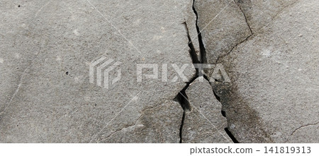 Large cracks and deep fissures in the old concrete surface. Large cracks and deep fissures in the old concrete surface. 141819313