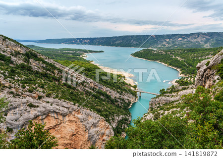 The lake Lac de Sainte-Croix in France has clear cyan water. The Verdon River flows from the Verdon Canyon into the lake 141819872