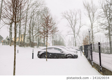 Cars covered with thick layer of snow on outdoor parking lot Cars covered with thick layer of snow on outdoor parking lot 141820034
