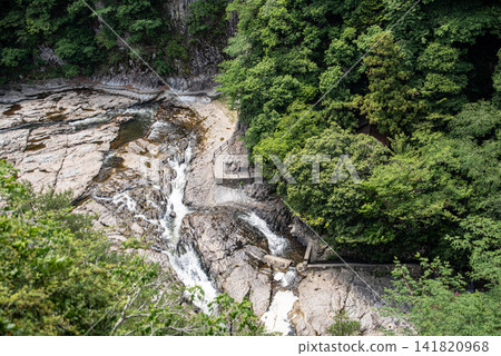 The rocky cliffs and clear stream of Dangyo Gorge, surrounded by forests The rocky cliffs and clear stream of Dangyo Gorge, surrounded by forests 141820968