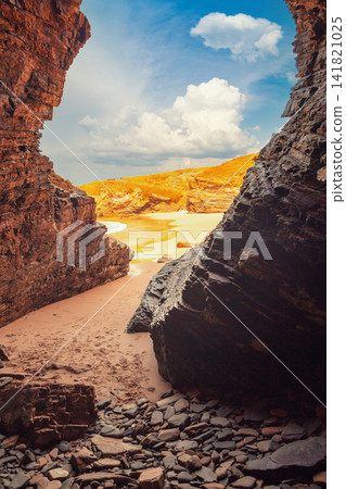 Rocky seashore. Natural landscape. Rocky grotto at low tide Rocky seashore. Natural landscape. Rocky grotto at low tide 141821025