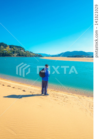 A man walks on the beach. Man looks at the sea A man walks on the beach. Man looks at the sea 141821029