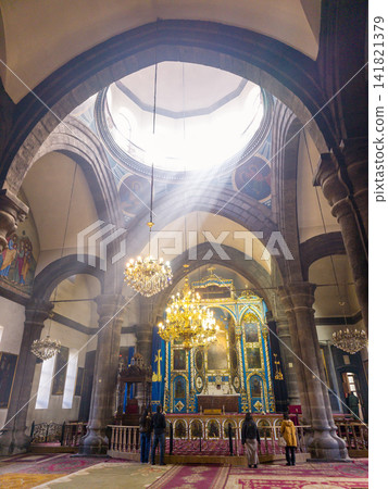 Inside a historic church, light beams highlight ornate details Inside a historic church, light beams highlight ornate details 141821379