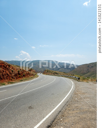 Winding mountain road with no vegetation or animals Winding mountain road with no vegetation or animals 141821531