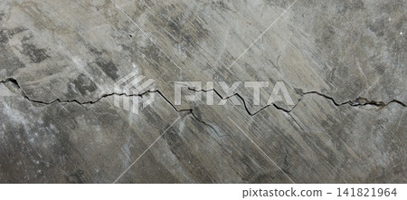 Large jagged crack on polished dark concrete wall Large jagged crack on polished dark concrete wall 141821964