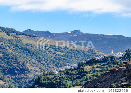 Picturesque view of a village Pampaneira located on a mountainside in the Sierra Nevada region of Spain Picturesque view of a village Pampaneira located on a mountainside in the Sierra Nevada region of Spain 141822416
