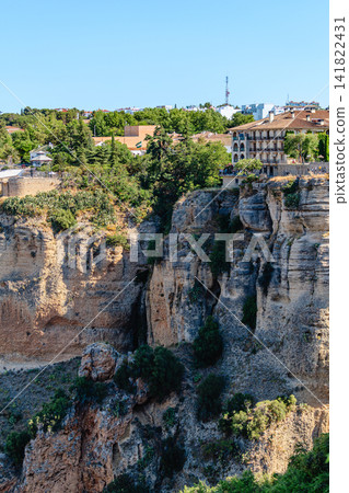 The picturesque town of Ronda in Spain is located on a cliff. The picturesque town of Ronda in Spain is located on a cliff. 141822431