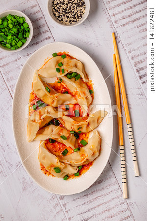 Dumplings with spicy sauce served on a plate Dumplings with spicy sauce served on a plate 141822481