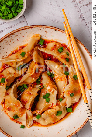 Dumplings with spicy sauce served on a plate Dumplings with spicy sauce served on a plate 141822482