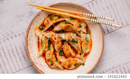 Dumplings with spicy sauce served on a plate Dumplings with spicy sauce served on a plate 141822483
