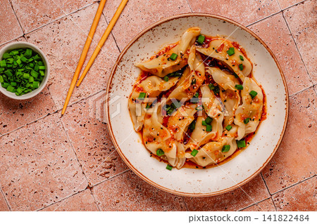 Dumplings with spicy sauce served on a plate Dumplings with spicy sauce served on a plate 141822484