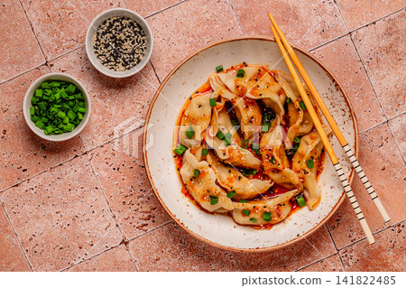 Dumplings with spicy sauce served on a plate Dumplings with spicy sauce served on a plate 141822485