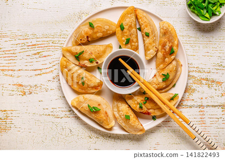 Dumplings served on a plate with soy sauce Dumplings served on a plate with soy sauce 141822493