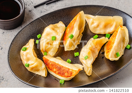 Dumplings served on a plate with green onions Dumplings served on a plate with green onions 141822510