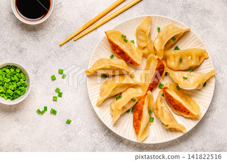 Dumplings served on a plate with green onions Dumplings served on a plate with green onions 141822516