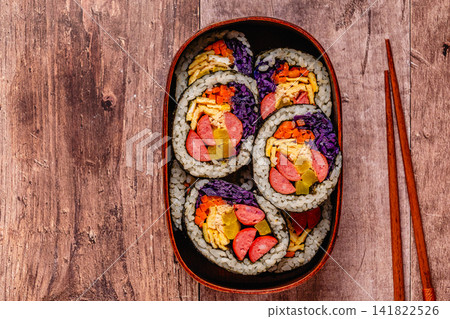 Colorful kimbap (or gimbap) with vegetables and sausage in a wooden box Colorful kimbap (or gimbap) with vegetables and sausage in a wooden box 141822526