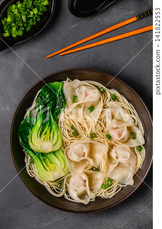 Noodle soup with dumplings (wontons) and cabbage bok choy 141822553