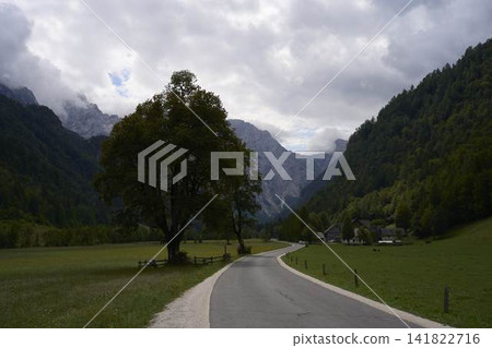 Breathtaking panoramic view of green Logar valley and high alpine mountain peaks in Slovenia Breathtaking panoramic view of green Logar valley and high alpine mountain peaks in Slovenia 141822716