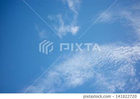 A low-pressure system is approaching, and the sky is filled with cirrocumulus clouds. A low-pressure system is approaching, and the sky is filled with cirrocumulus clouds. 141822720